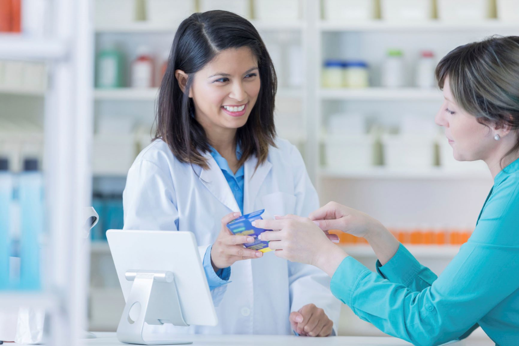 Woman talking to pharmacist 