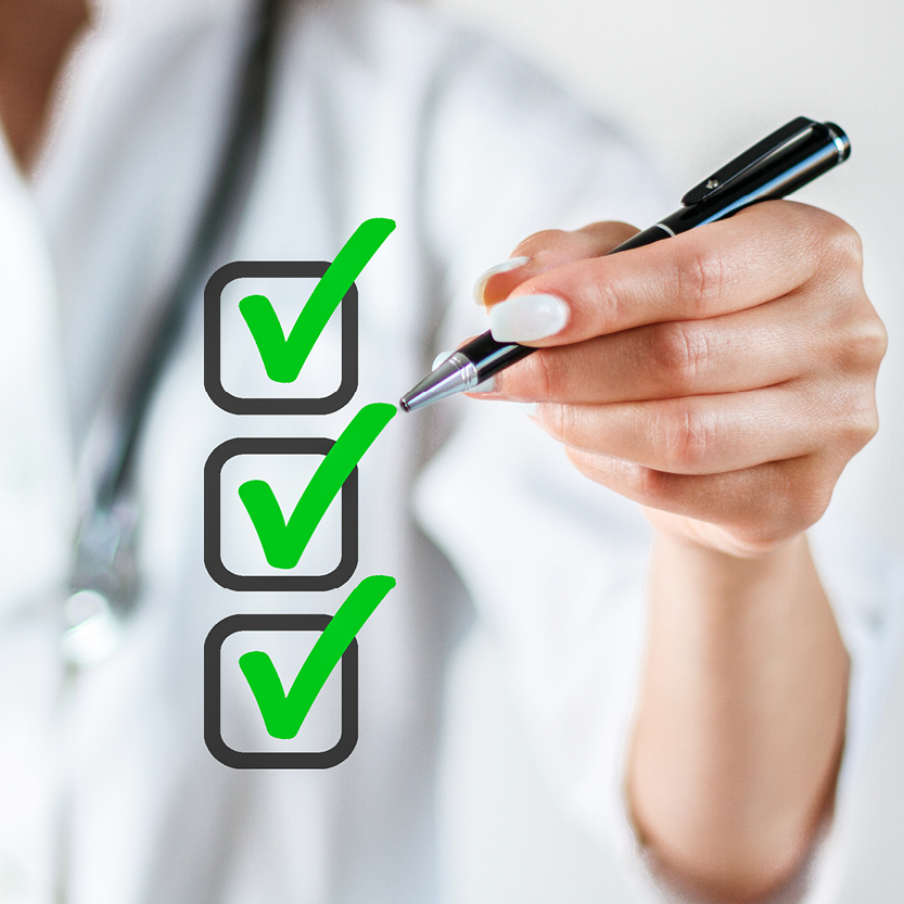 Hand making green check marks in boxes