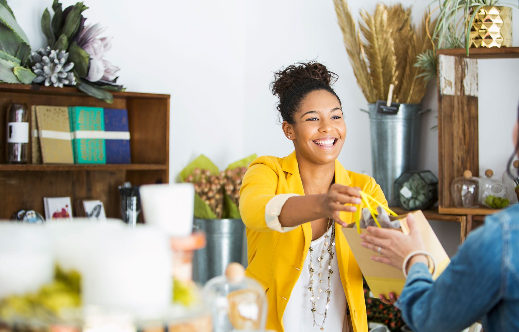Cashier handing bag to customer