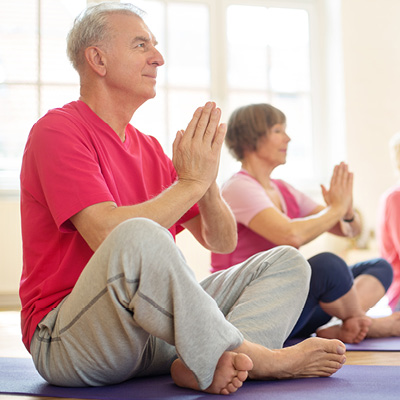 older man doing yoga 