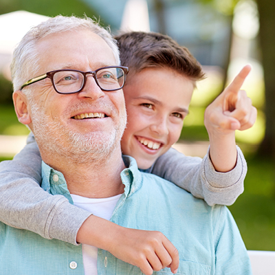 Man wearing glasses and boy pointing