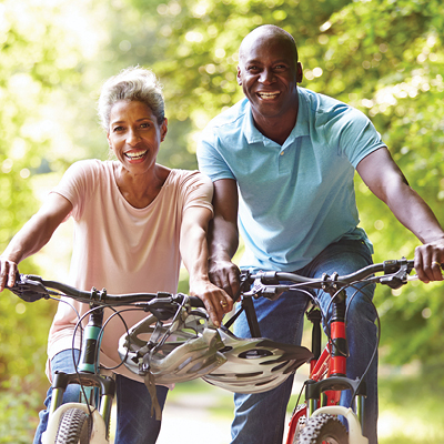 two people aged over 50 riding bikes 