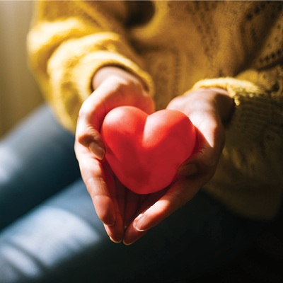 a person holding a heart in their hands