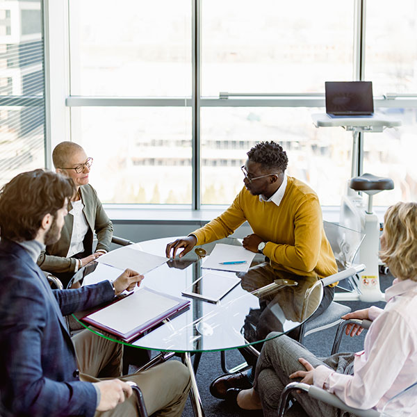 Man Talking to Three People