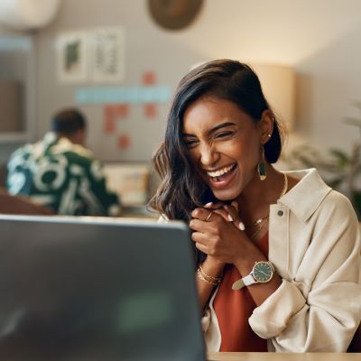 Person smiling at laptop
